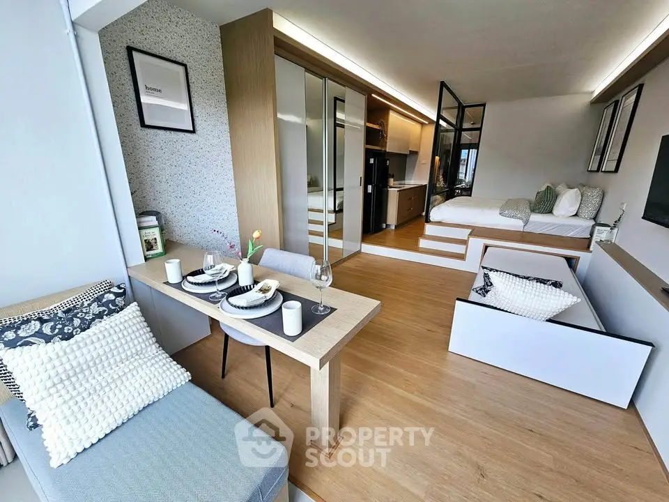 Modern studio apartment with open layout, stylish decor, and cozy dining area