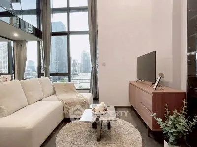 Modern living room with large windows and city view, featuring cozy white sofa and sleek TV setup.