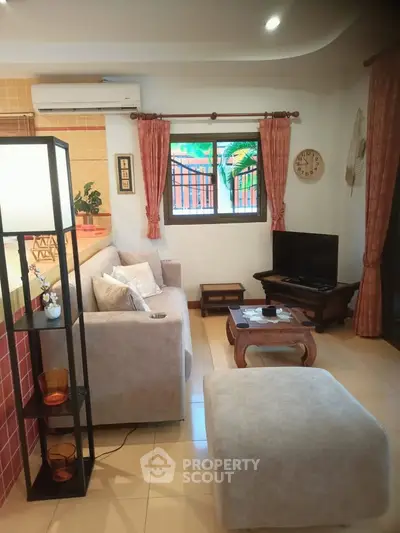 Cozy living room with modern furniture and natural light, perfect for relaxation and entertainment.