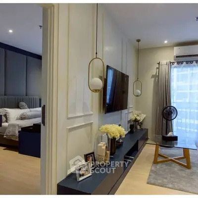 Modern living room with stylish decor and adjacent bedroom in a cozy apartment.