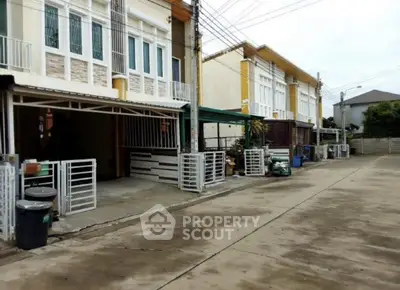 Modern townhouse exterior with gated parking and clean driveway