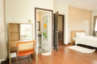 Bright and cozy bedroom with wooden flooring and modern furniture