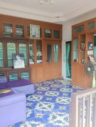 Charming living room with vibrant blue patterned tiles and elegant wooden cabinetry.