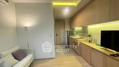 Modern studio apartment with sleek kitchen and cozy living area