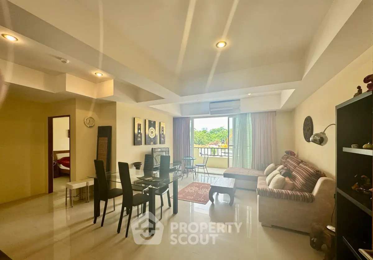 Spacious living room with modern decor and balcony view