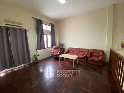 Spacious living room with parquet flooring and modern furniture