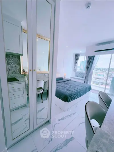 Luxurious modern bedroom with marble flooring and city view, featuring elegant furnishings and ample natural light.