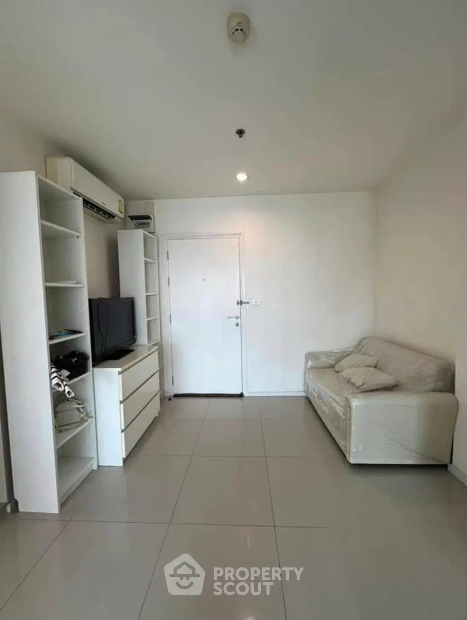 Modern living room with sleek white furniture and minimalist design, perfect for urban living.
