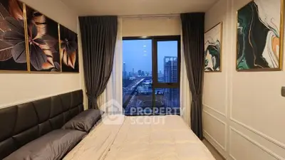 Stylish bedroom with city view, modern decor, and elegant artwork