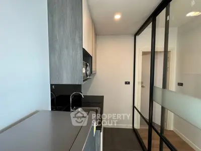 Modern compact kitchen with sleek design and glass partition