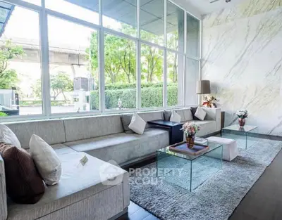 Spacious modern living room with large windows and elegant decor in a luxury property.