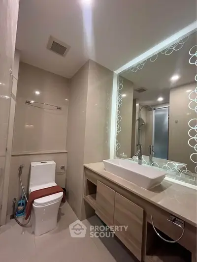 Modern bathroom with sleek fixtures and large mirror