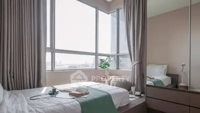 Bright and cozy bedroom with large windows and modern decor