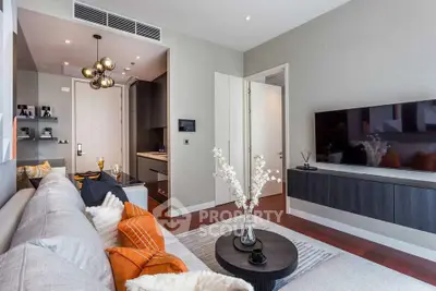 Modern living room with stylish decor and open layout, featuring a cozy sofa and wall-mounted TV.
