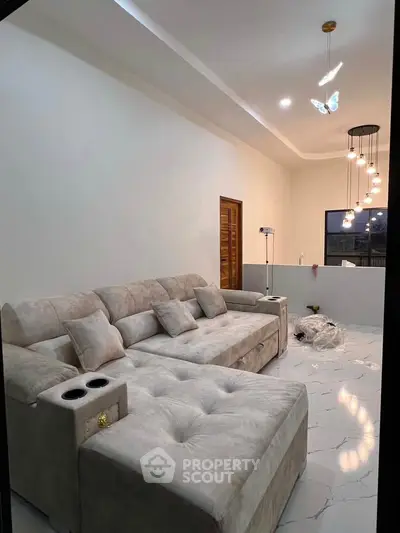 Modern living room with plush sectional sofa and elegant lighting