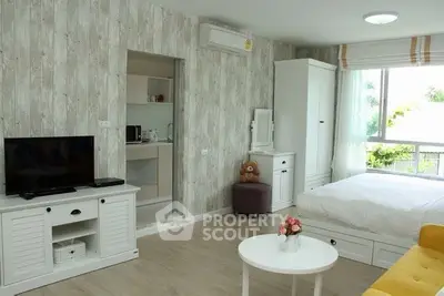 Charming studio apartment with modern decor, featuring a cozy living area and natural light.