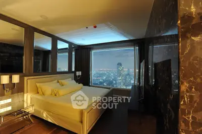 Luxurious bedroom with stunning city view from large window, elegant decor and modern furnishings.