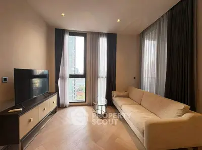 Modern living room with sleek design, featuring a cozy sofa, large TV, and floor-to-ceiling windows with city view.