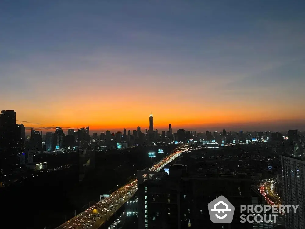 Stunning city skyline view at sunset with vibrant colors and bustling traffic below.