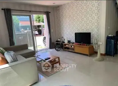 Spacious living room with modern decor and large windows offering natural light.