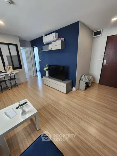 Modern living room with wooden flooring and sleek furniture