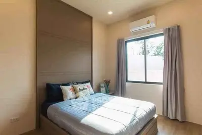 Cozy bedroom with large window and modern decor
