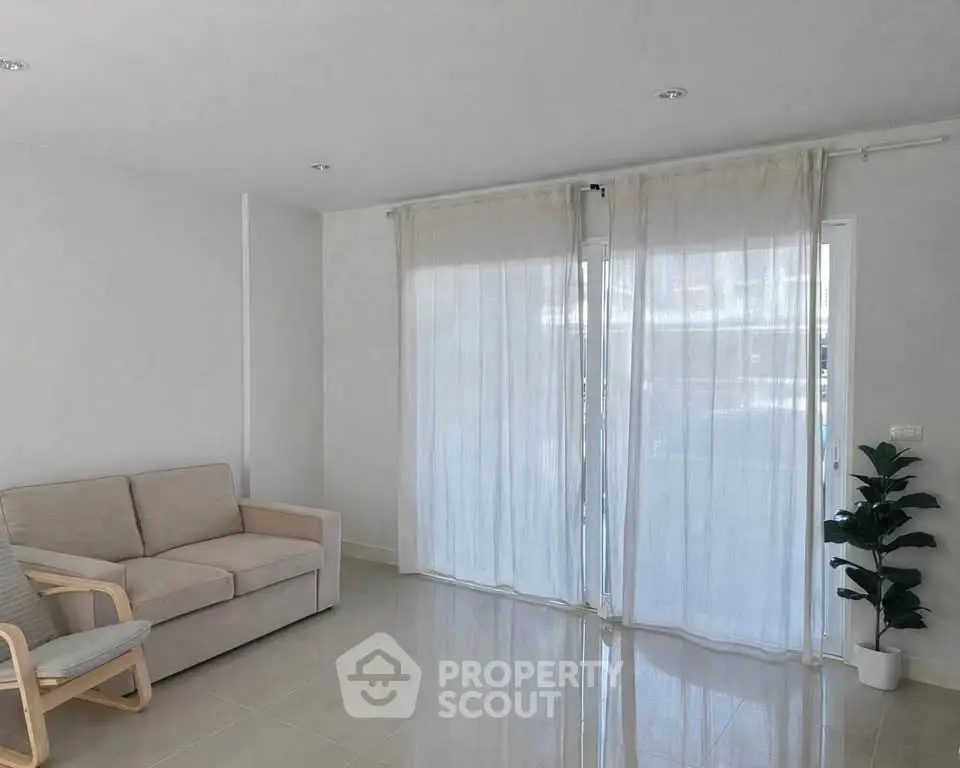 Spacious living room with modern sofa and large windows for natural light