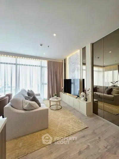 Luxurious living room with modern decor and large windows offering natural light.