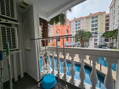 Charming balcony with pool view in vibrant residential complex
