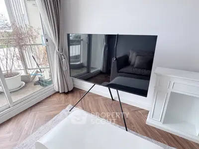 Modern living room with sleek TV and elegant balcony view