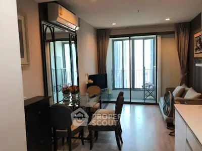 Modern living room with dining area and balcony access in a stylish apartment.