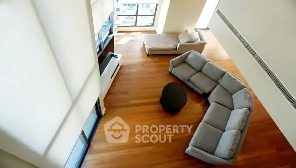 Spacious modern living room with large windows and stylish furniture