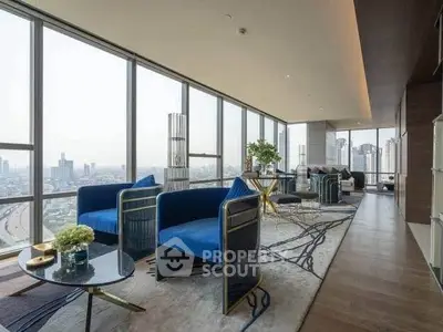 Luxurious corner unit living room with panoramic city views and modern blue furnishings.