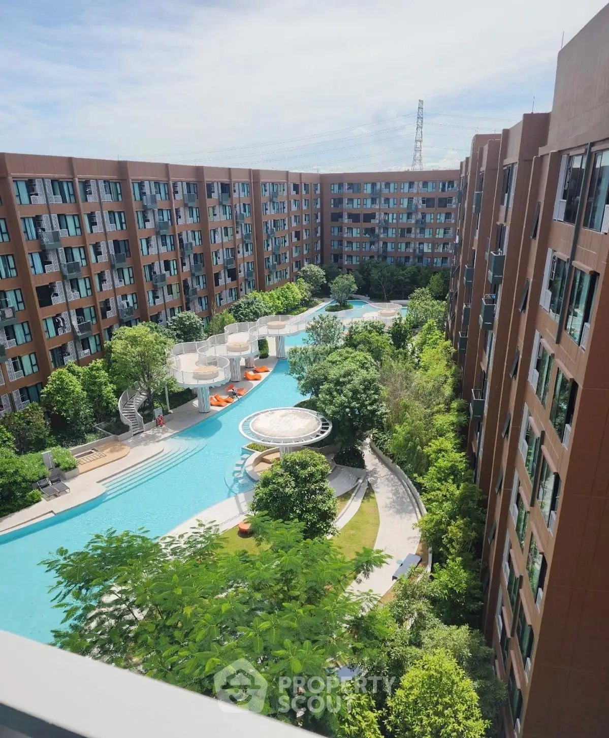 Luxurious apartment complex with stunning pool and lush greenery view