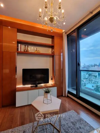 Luxurious living room with chandelier and city view, featuring elegant decor and modern entertainment setup.