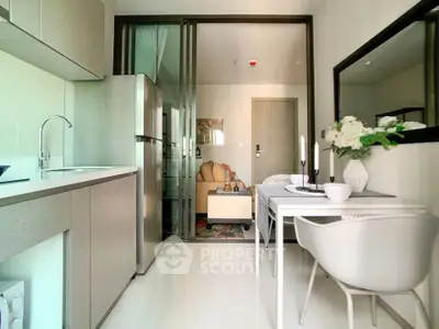 Modern open-layout kitchen and dining area with sleek design and natural light