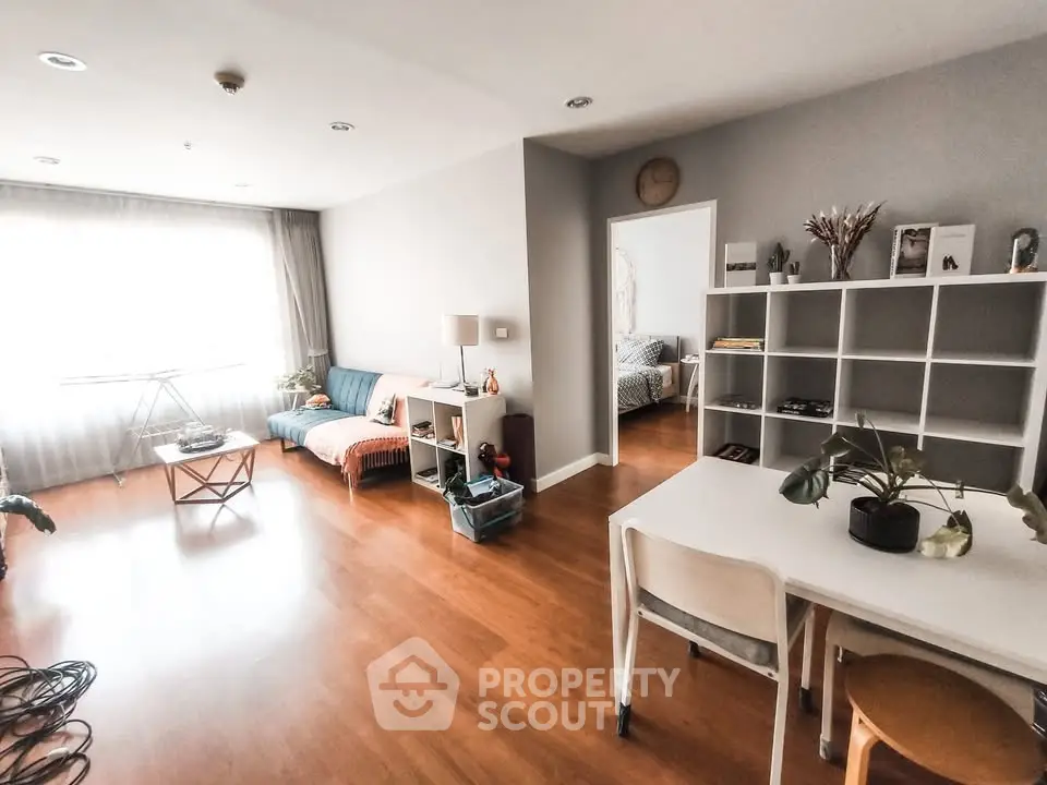 Spacious living room with modern decor and wooden flooring