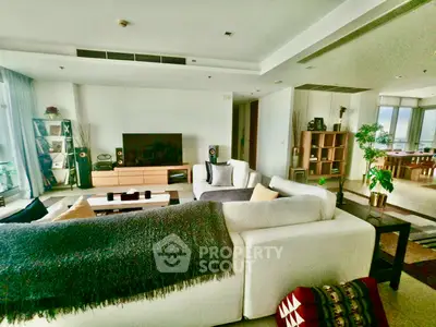 Spacious modern living room with elegant decor and large windows offering natural light.