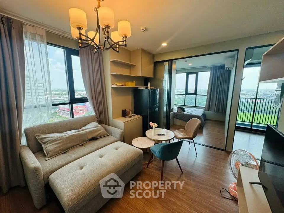 Modern living room with cozy sofa and balcony view in high-rise apartment