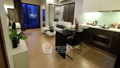 Modern open-plan living room with sleek kitchen and balcony view in urban apartment.