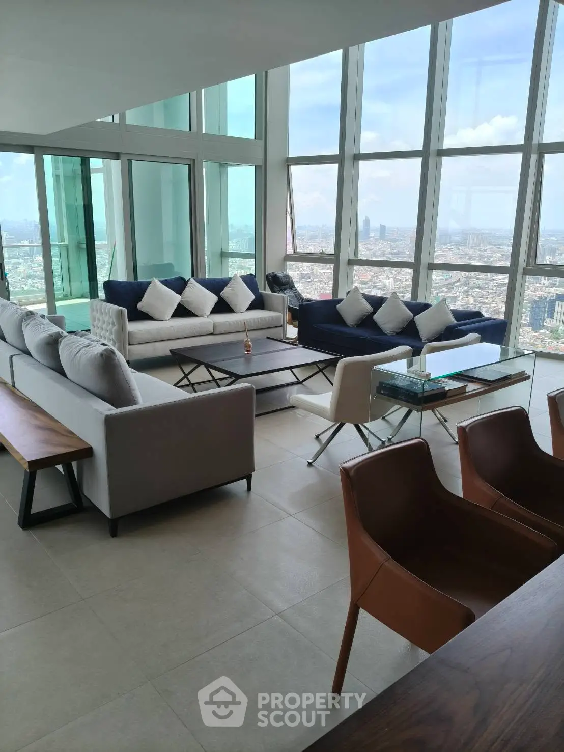 Luxurious high-rise living room with panoramic city views and modern furnishings.