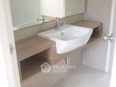 Modern bathroom with stylish sink and wooden vanity