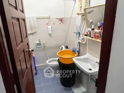 Compact bathroom with essential fixtures and storage solutions