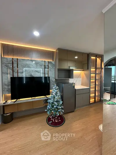 Modern living room with sleek TV setup and festive decor