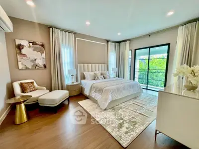 Luxurious bedroom with elegant decor and balcony access, featuring modern furniture and ambient lighting.