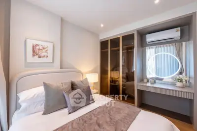 Elegant bedroom with modern decor and built-in wardrobe, featuring soft lighting and stylish furnishings.