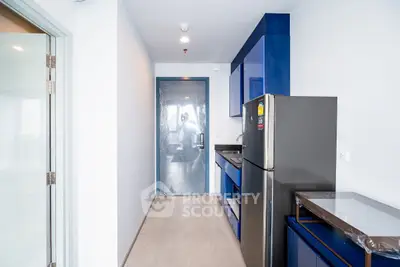 Modern kitchen with sleek blue cabinets and stainless steel appliances