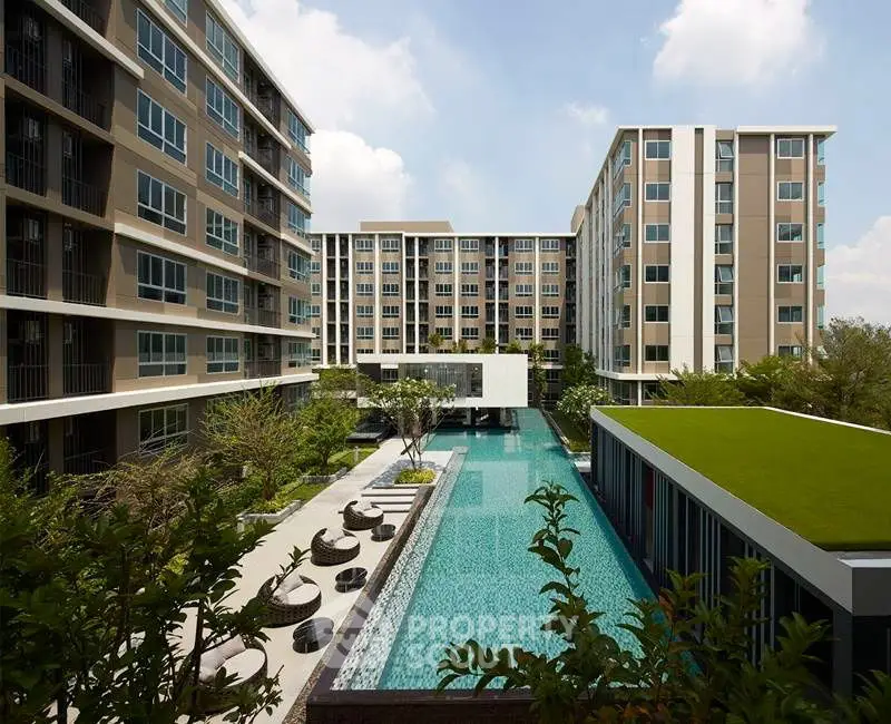 Modern apartment complex with stunning pool and lush greenery, perfect for luxury urban living.