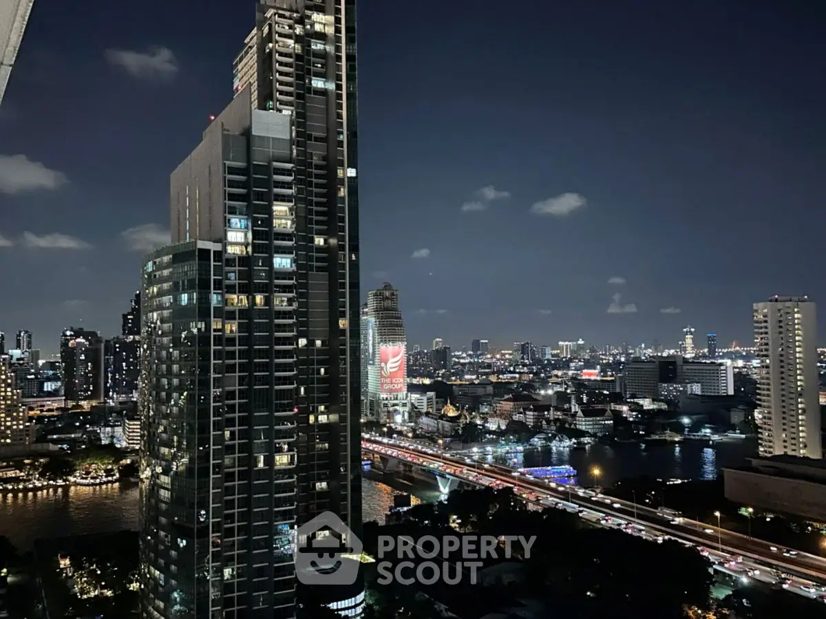 Stunning cityscape view from high-rise building at night with illuminated skyline.