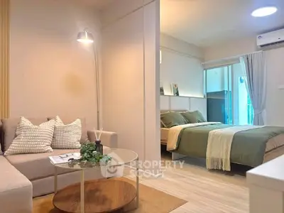 Modern open-plan living room and bedroom with stylish decor and natural light.